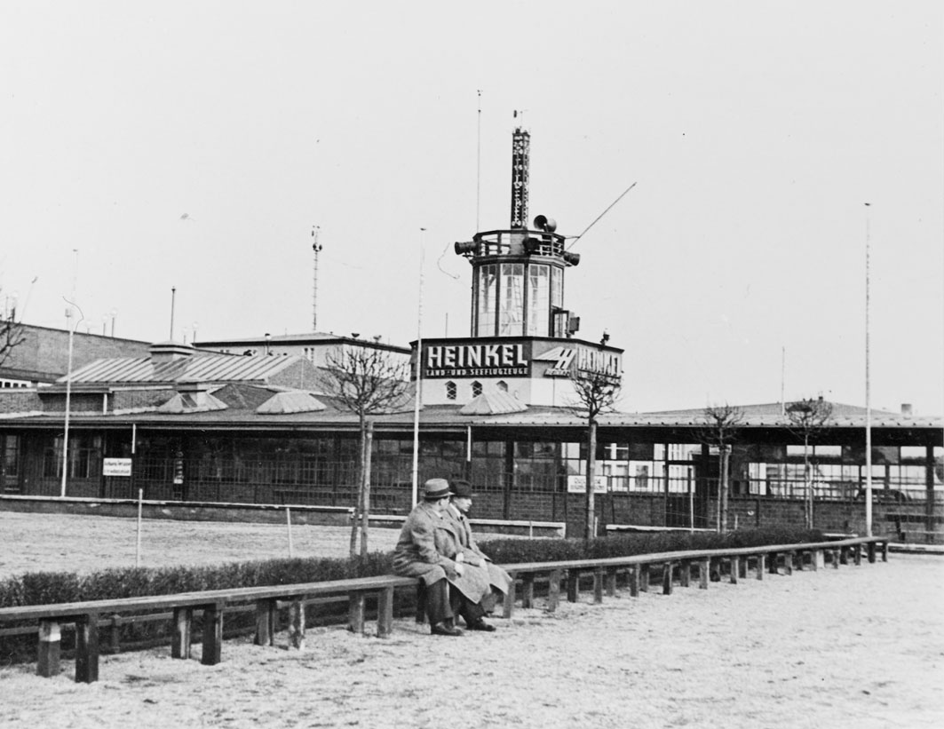 By tockholm Transport Museum (Flickr: Airport Tempelhof in Berlin, Germany 1937) [<a href="https://www.flickr.com/commons/usage/">No restrictions</a> or Public domain], <a href="https://commons.wikimedia.org/wiki/File%3AHeinkel_at_Tempelhof_Airport_in_Berlin%2C_Germany_1937.jpg">via Wikimedia Commons</a>